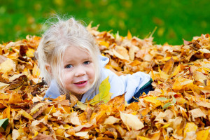 Little Girl in Leaf Pile
